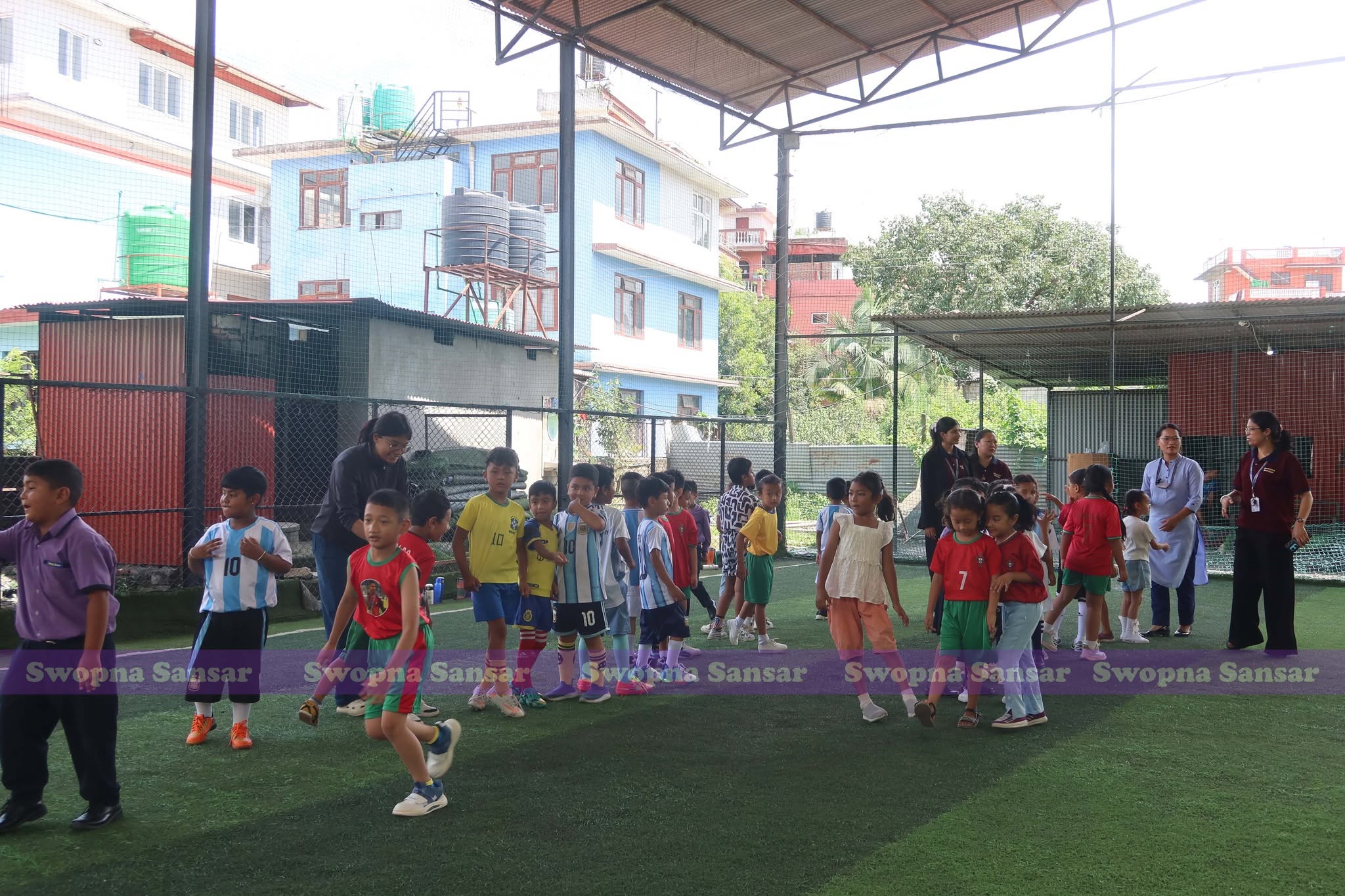 Students playing futsal on the covered school court.